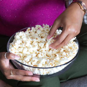 Cousin Willie's White Cheddar popcorn on a kitchen counter, highlighting whole grain and gluten-free.