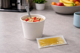 Crait honey packets paired with tea or hot water for easy flavor boost.