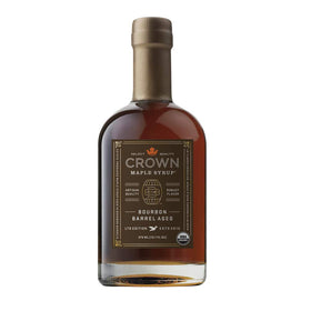 Pouring Crown Maple Bourbon Barrel Aged syrup over pancakes for brunch flavor