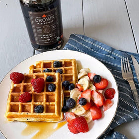 Crown Maple Bourbon Barrel-Aged syrup bottle showing amber glow and smoky notes