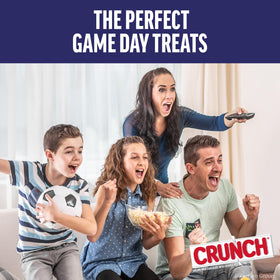 Unwrapped CRUNCH bar reveals creamy milk chocolate and crunchy pieces.