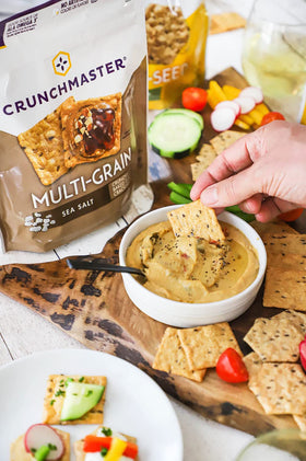 Crunchmaster crackers closeup shows crisp texture, perfect for gluten-free snacking.