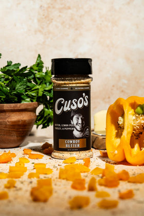 Cuso Cuts Cowboy Butter Seasoning enhances chicken and vegetables with herb-infused butter.