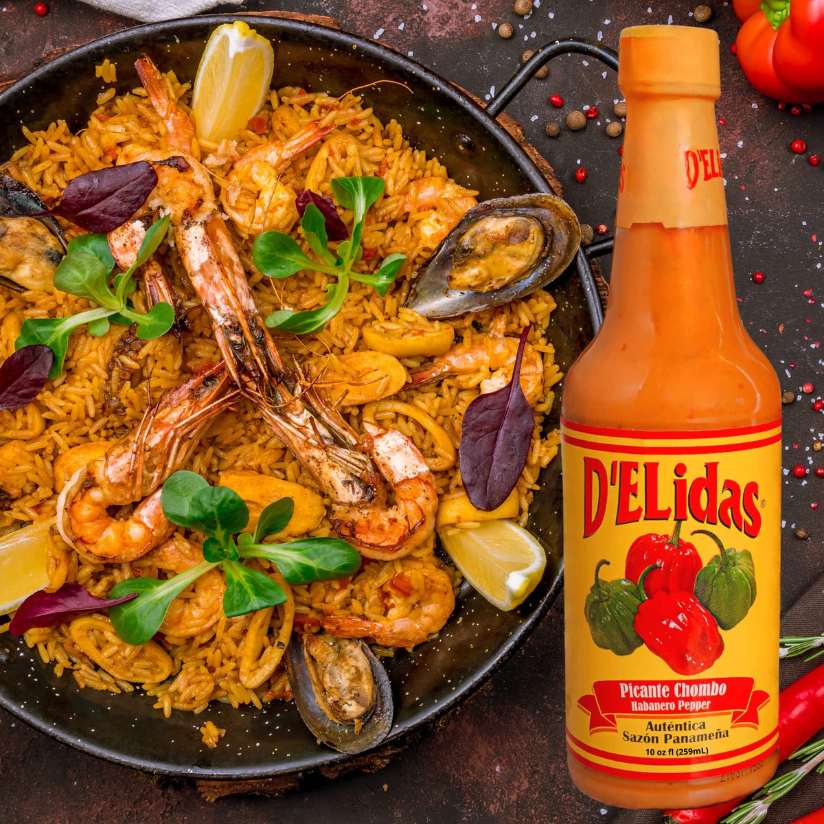 D'ELidas Habanero Hot Sauce paired with paella for vibrant seasoning.