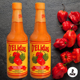 D'ELidas Habanero Hot Sauce pour shot showing vibrant color and heat.