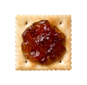 Dalmatia Fig Spread on a cheese board with brie and grapes