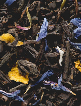Close-up of Jardin Bleu sachets ready to steep with a floral accent.