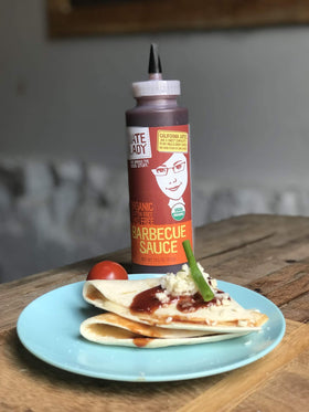 Date Lady BBQ Sauce us-made label on bottle emphasizing small-batch quality.
