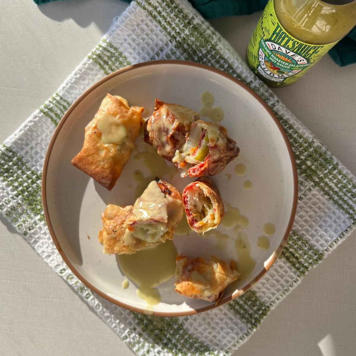 Dave's Gourmet Creamy Jalapeño Sauce on a plate, elevating breakfast, lunch, or dinner with moderate heat.