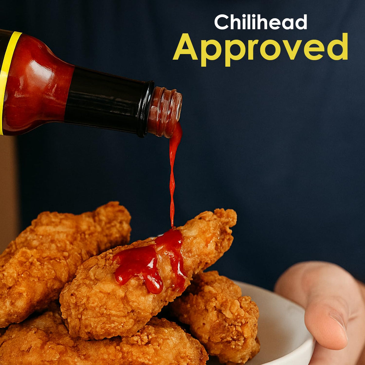 Wings dipping closeup with Dave's Gourmet Insanity adds intense finish