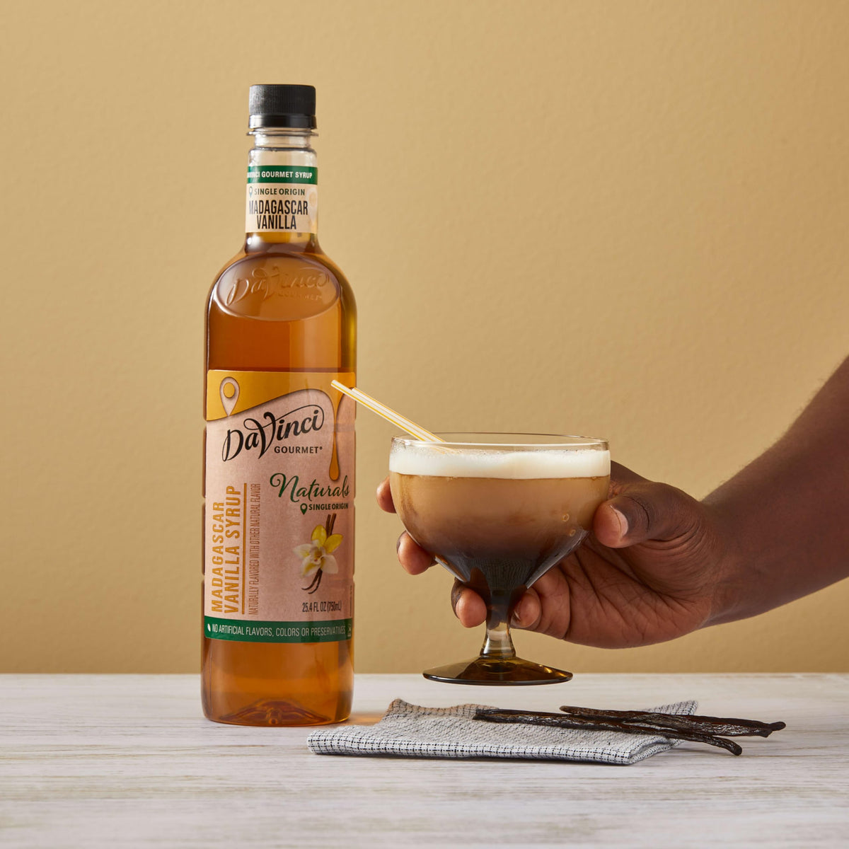 Vanilla beans and bottle together signaling simple ingredients