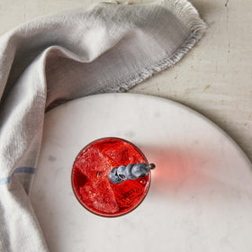 DaVinci Sugar-Free Huckleberry Syrup in tea glass enhancing refreshing flavor.