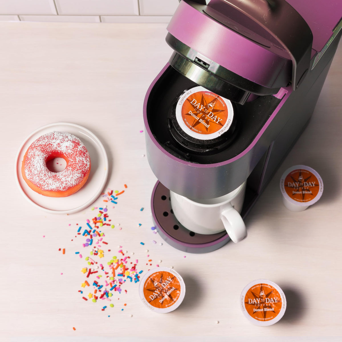 Day To Day Coffee Donut Blend pod in Keurig brewer showing compatibility.