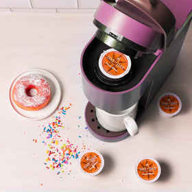 Day To Day Coffee Donut Blend pod in Keurig brewer showing compatibility.