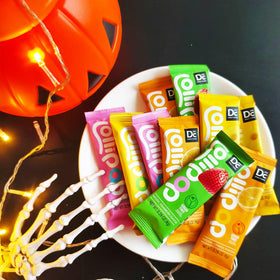 DC24 DAILY CARE orange flavor lollipop close-up, bright citrus taste.