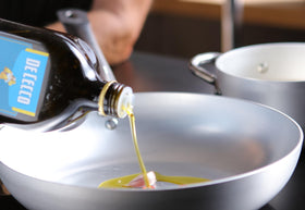 De Cecco Classico olive oil kitchen-use image showing drizzle on vegetables
