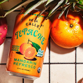 De La Calle Tepache Mandarin ingredients closeup emphasizing pineapple and spices in an organic recipe