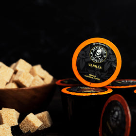 Death Wish Coffee vanilla beans beside pods highlight natural aroma.