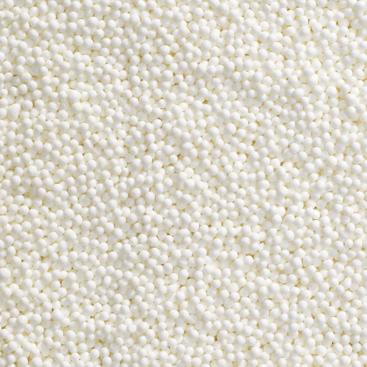 DecoPac white nonpareils in a handheld container for easy, mess-free decorating.