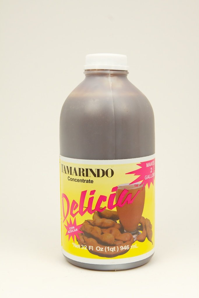 Delicia Tamarind Concentrate bottle pour adds tangy depth to sauces and beverages.