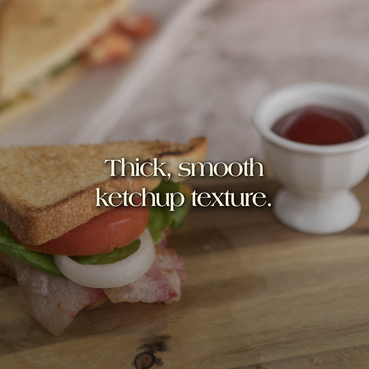 Den Nigris Excellence Ketchup pour showing smooth, velvety texture.