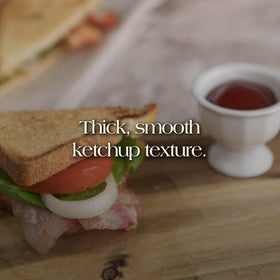 Den Nigris Excellence Ketchup pour showing smooth, velvety texture.