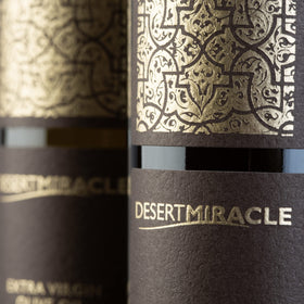 DesertMiracle production facility and stone wall illustrating careful farming.