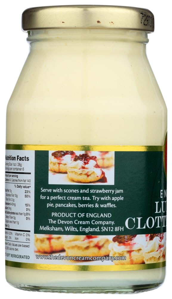 Devon Cream clotted cream on a scone beside tea and jam.