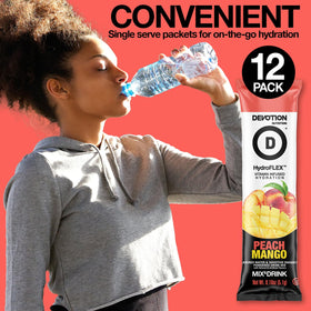 Devotion HydroFLEX Peach Mango stirred into sparkling water for flavor and hydration