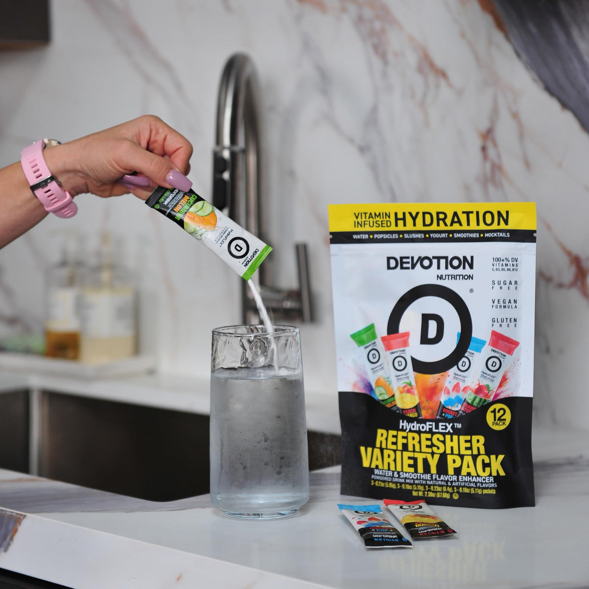 Devotion Nutrition HydroFLEX prepared drink with ice, emphasizing crisp strawberry watermelon taste.
