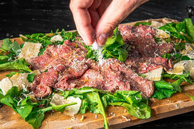 Diamond Crystal kosher salt pouring into measuring spoon for precise seasoning