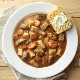 DINTY MOORE Beef Stew in a bowl with carrots and potatoes.