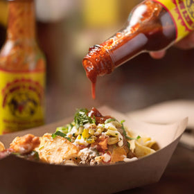 Wings plated with Dirty Dick's Original Hot Sauce for extra zest.