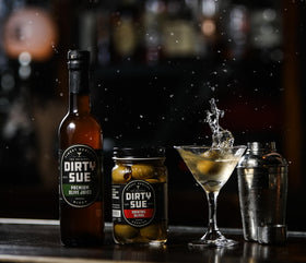 Dirty Sue bottles in a busy cocktail station for service.
