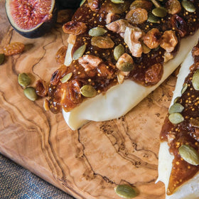 Divina fig spread on crostini with cheese for a savory bite.