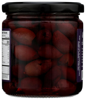 DIVINA smoked Kalamata olives sliced on a board for salads and antipasti.
