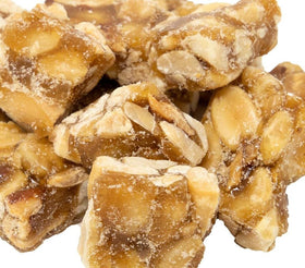 DM Sweets packaging closeup showing golden brittle coating and peanuts.
