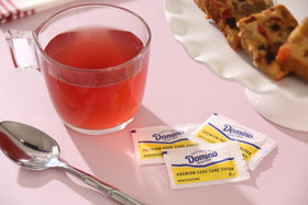 Close-up of Domino sugar packets highlighting neat single-serve portions.