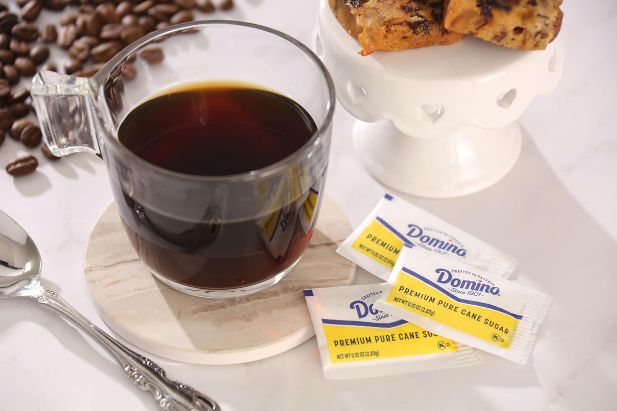 Domino sugar packets at a coffee station setup for quick self-serve.