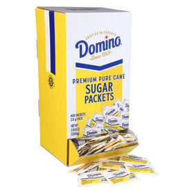 Domino sugar packets in a dispenser box for quick, mess-free service in busy environments.