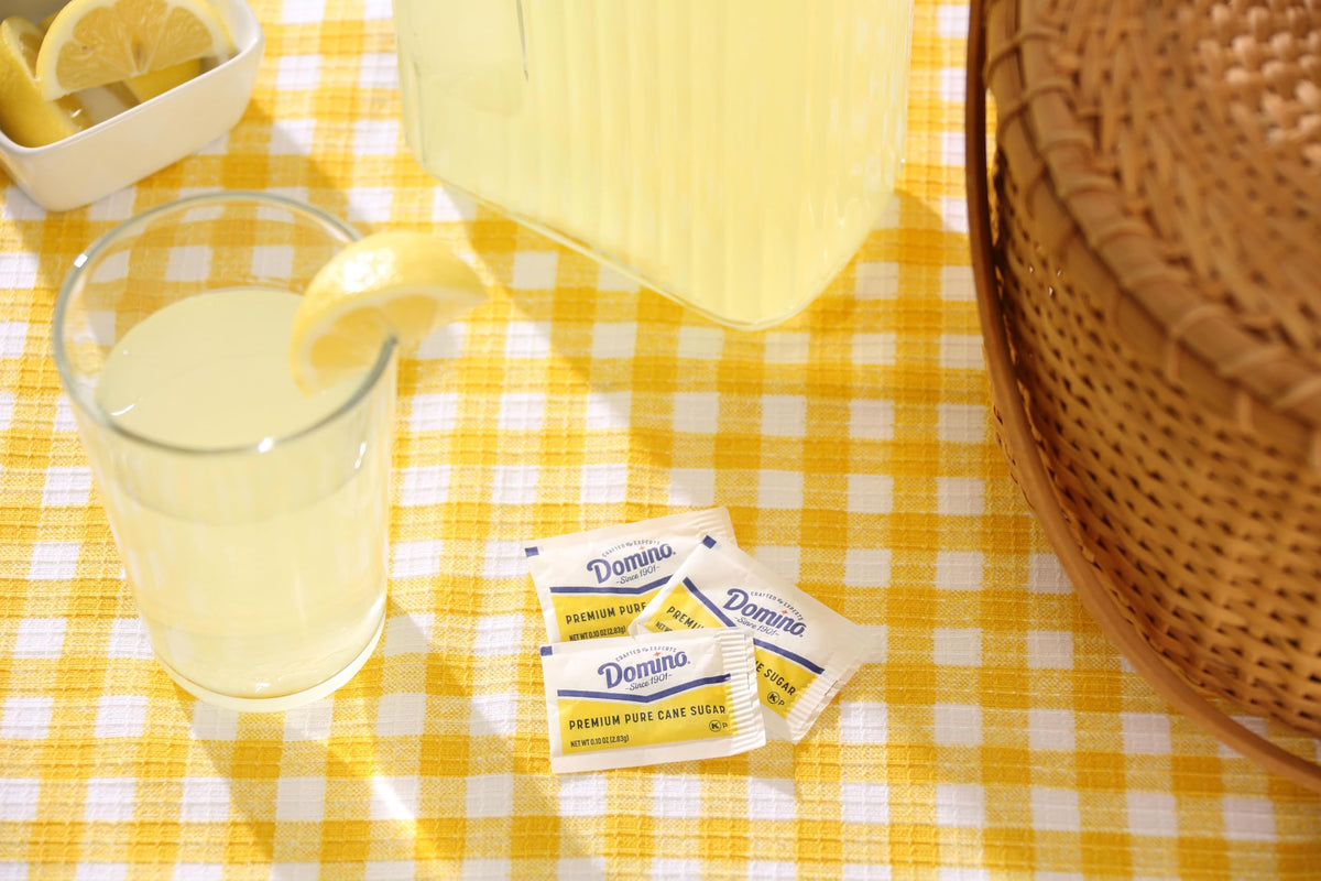 Domino sugar packets in an office breakroom for tidy sweetness.
