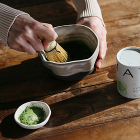 DONA hot or iced matcha served in a cup.