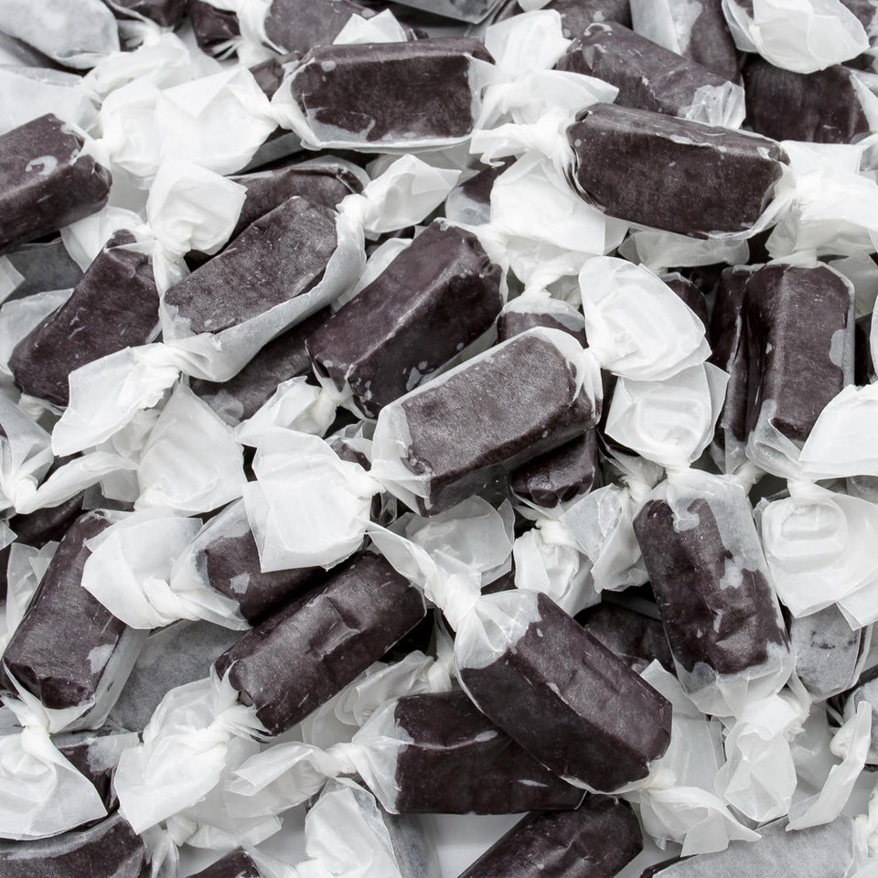 Donty-Tonty black licorice caramel piece close-up, smooth texture ideal for snacking.