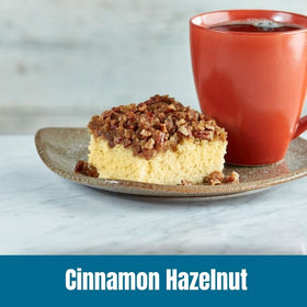 Door County Coffee Cinnamon Hazelnut cup steaming, inviting breakfast aroma.