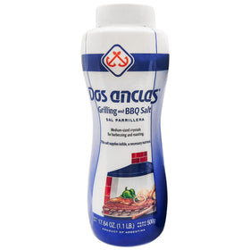 Dos Anclas Sal Parrillera medium grain salt on a grill pan enhancing steak flavor.