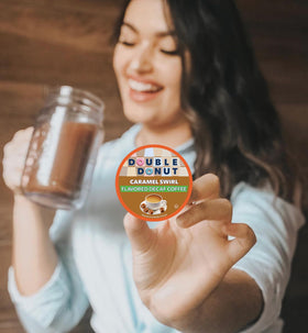 Double Donut Caramel Swirl decaf pods ready to brew in a cozy home office.