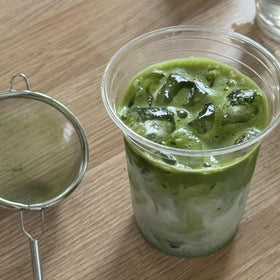 Dr. Weil Matcha Kari iced matcha in a tall glass with straw.