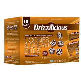 Drizzilicious Cookies and Cream mini rice cakes close-up with white drizzle, tasty vegan snack.