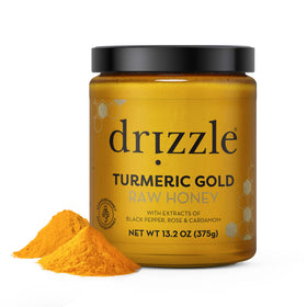 Drizzle Turmeric Gold Raw Honey jar ready to sweeten tea with turmeric warmth
