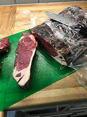 DryAgingWraps meat on fridge rack showing controlled aging and airflow.